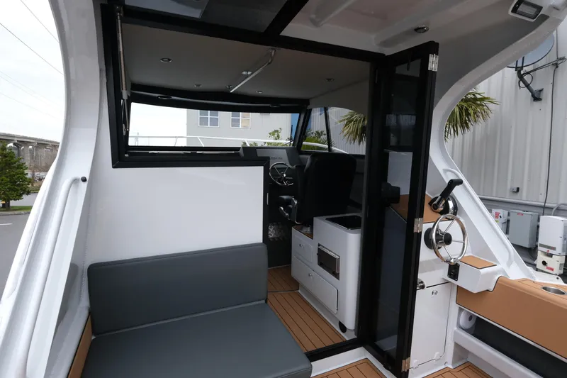 Slide: The Image of Interior view of 2026 Makaira 28 boat with seating and steering area. - 11