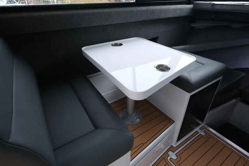 Slide: The Image of Interior of 2026 Makaira 28 boat with sleek seating and modern table design. - 13
