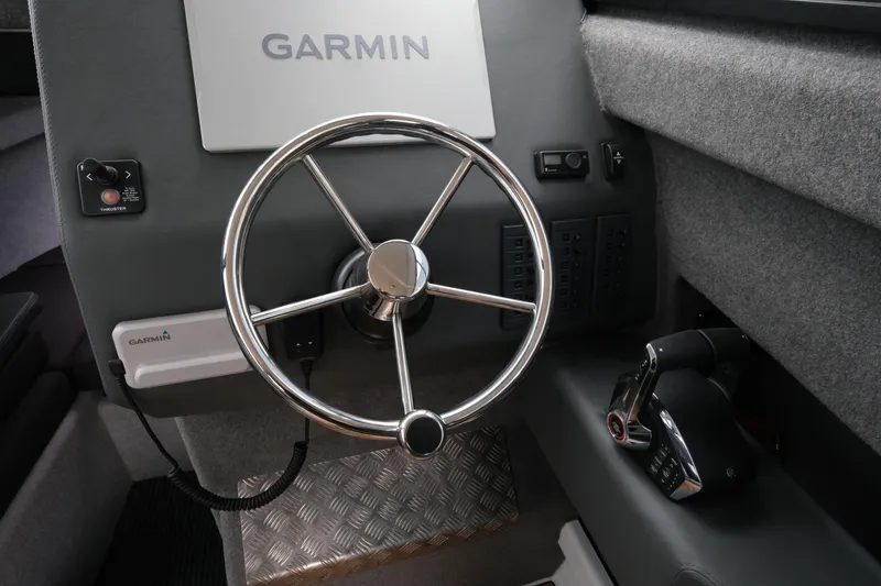 Slide: The Image of Steering wheel and controls of 2026 Makaira 28 boat with Garmin navigation system. - 15
