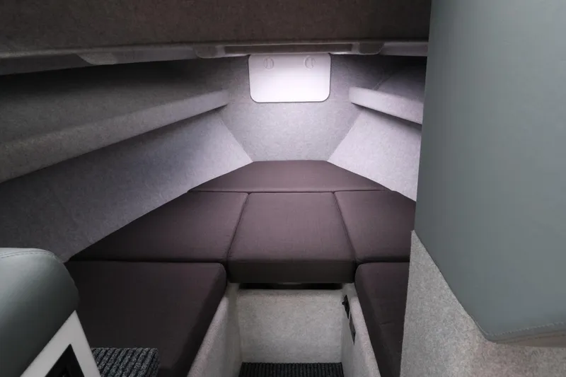 Slide: The Image of Interior cabin of 2026 Makaira 28 boat with cushioned seating and modern design. - 18