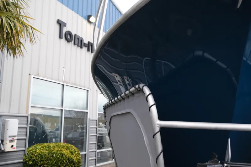 Slide: The Image of Makaira 28 boat (2026) near a building with reflective windows and greenery. - 23