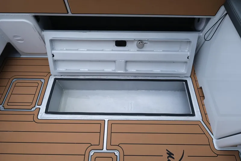 Slide: The Image of Makaira 28 boat storage compartment with open lid, showcasing sleek design, 2026 model. - 25