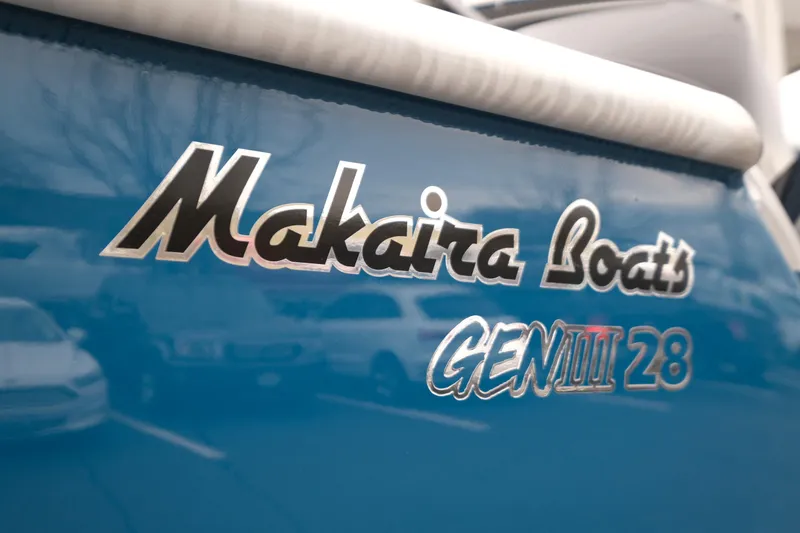 Slide: The Image of Makaira Boats GEN III 28 logo on blue surface, 2026 model. - 6