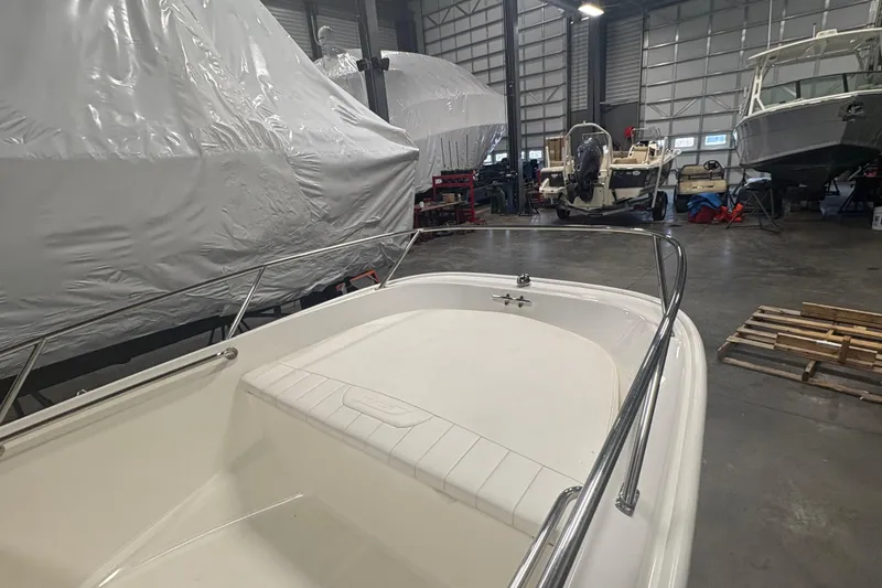 Slide: The Image of 2016 Boston Whaler 150 Super Sport in storage facility with other boats. - 10