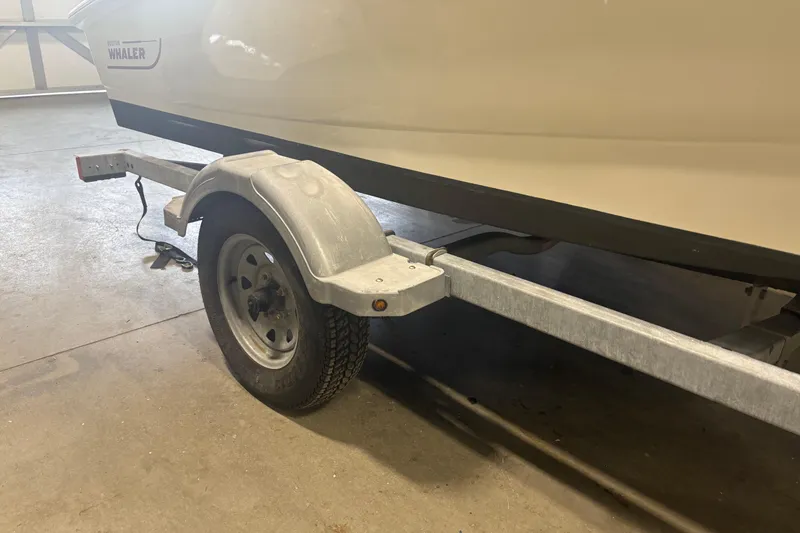 Slide: The Image of 2016 Boston Whaler 150 Super Sport on trailer in garage setting. - 11