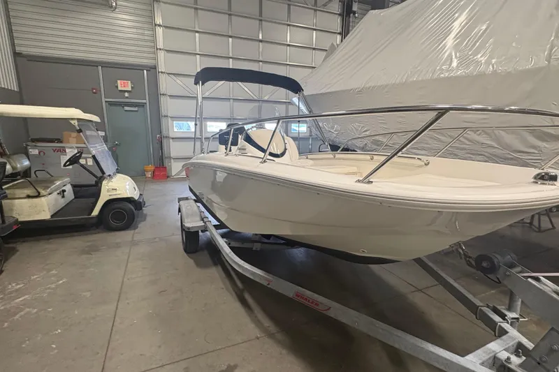 Slide: The Image of 2016 Boston Whaler 150 Super Sport boat on trailer in garage. - 3