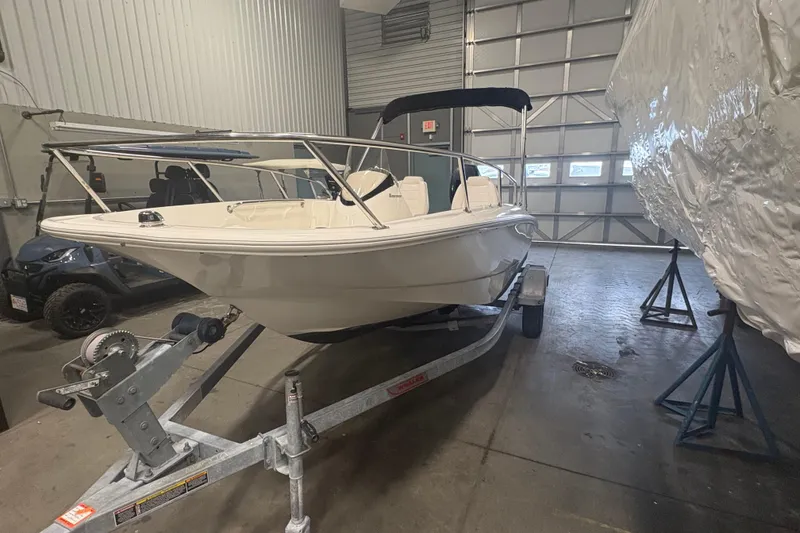 Slide: The Image of 2016 Boston Whaler 150 Super Sport boat on trailer in indoor storage facility. - 4