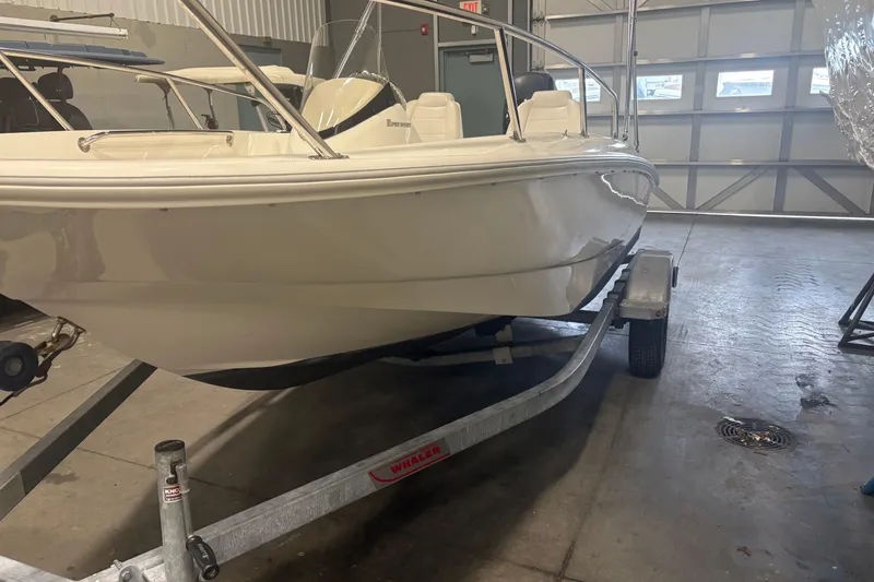 Slide: The Image of 2016 Boston Whaler 150 Super Sport boat on trailer in garage setting. - 5
