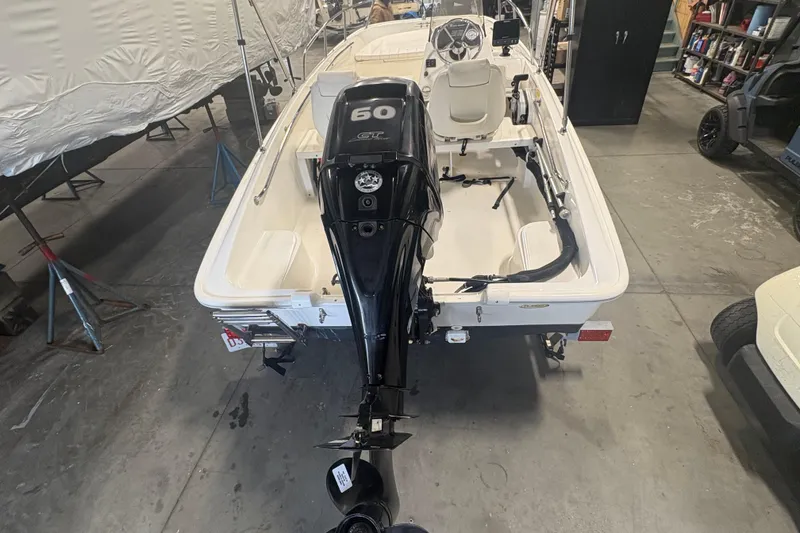 Slide: The Image of 2016 Boston Whaler 150 Super Sport boat with 60 HP engine in a garage. - 6