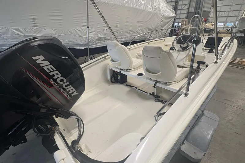 Slide: The Image of 2016 Boston Whaler 150 Super Sport boat with Mercury engine in a storage facility. - 7
