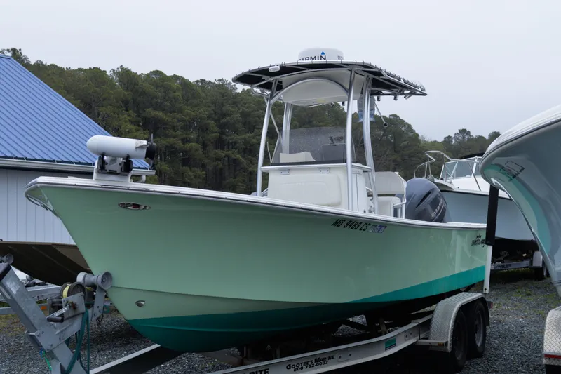 Slide: The Image of 2018 May-Craft 23 Cape Classic boat on trailer, parked outdoors near trees. - 5