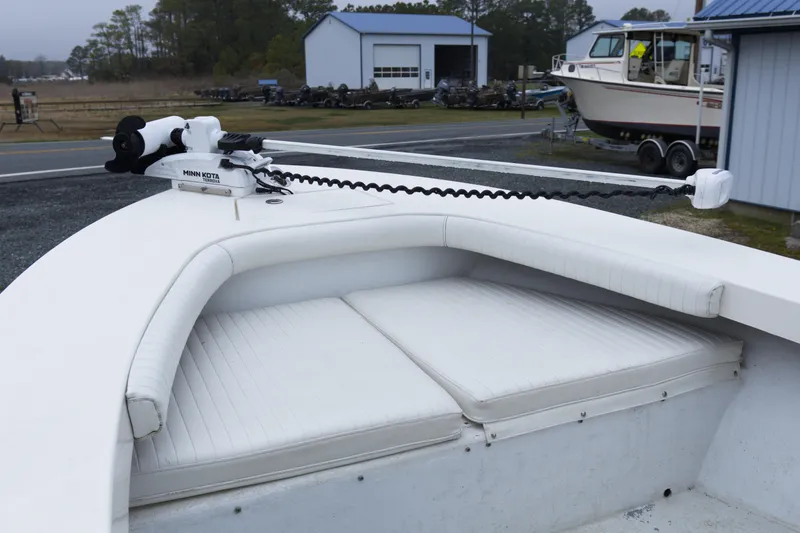 Slide: The Image of 2018 May-Craft 23 Cape Classic boat with Minn Kota trolling motor, parked near a workshop. - 7