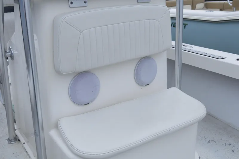 Slide: The Image of White seating area on a 2018 May-Craft 23 Cape Classic boat with built-in speakers. - 9