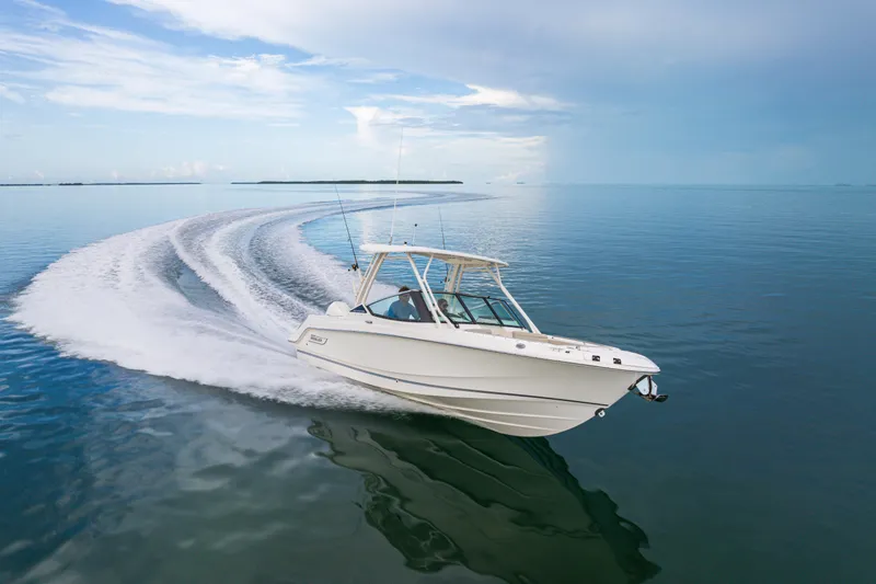 The Image of 2023 Boston Whaler 240 Vantage cruising on calm waters, leaving a smooth wake. - 0