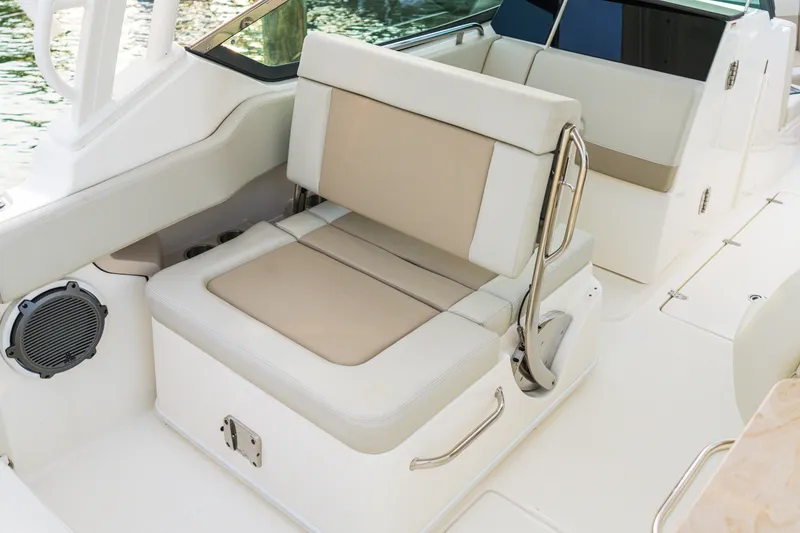 Slide: The Image of 2023 Boston Whaler 240 Vantage boat interior with beige and white seating. - 11