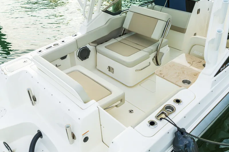 Slide: The Image of 2023 Boston Whaler 240 Vantage boat interior with beige seating and cup holders. - 13