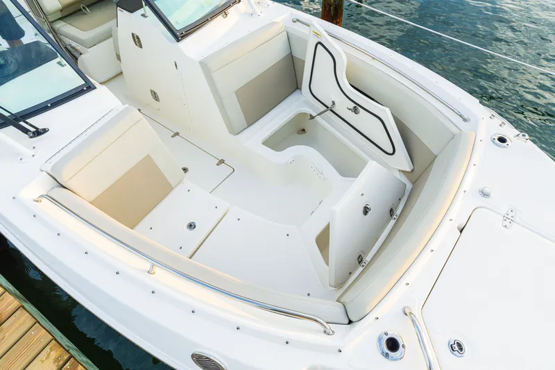 Slide: The Image of 2023 Boston Whaler 240 Vantage boat interior with seating and storage compartments. - 14