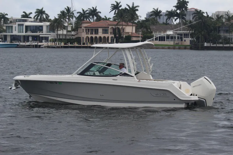 Slide: The Image of 2023 Boston Whaler 240 Vantage boat interior with cushioned seating and scenic water view. - 18