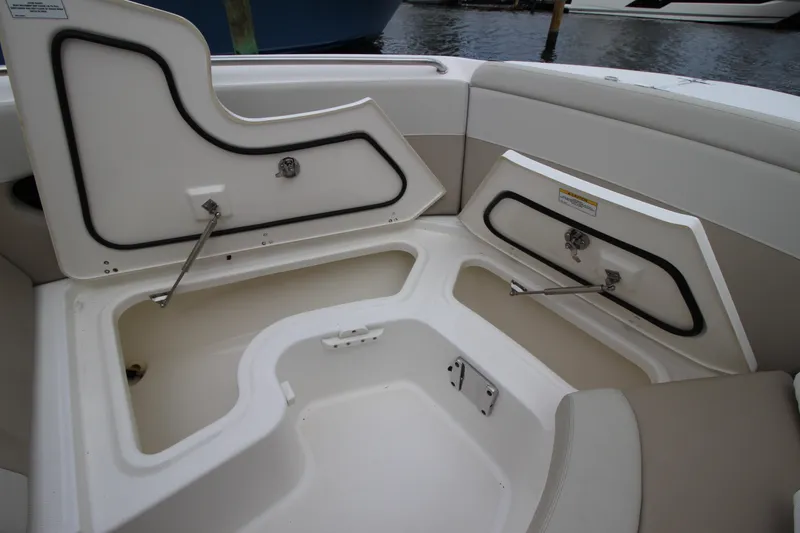 Slide: The Image of 2023 Boston Whaler 240 Vantage boat interior with seating and table, overlooking water. - 26