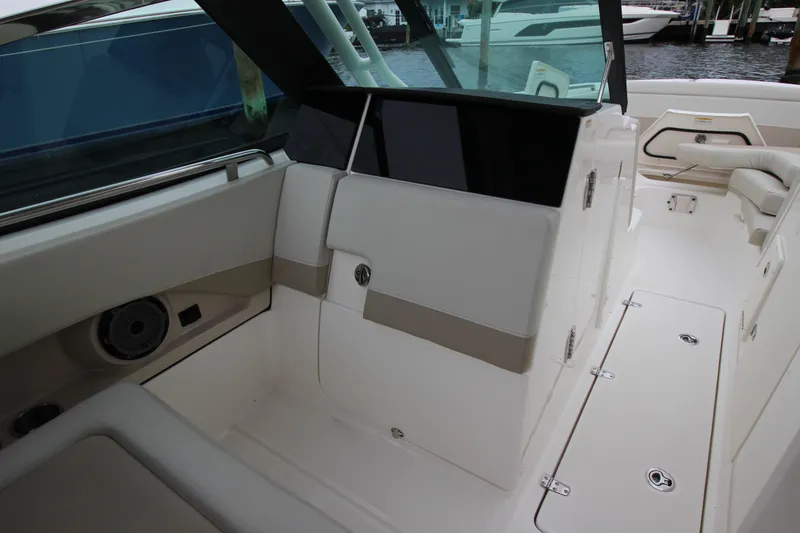 Slide: The Image of 2023 Boston Whaler 240 Vantage boat with Mercury engine on calm water. - 29