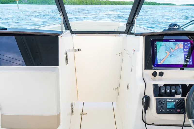 Slide: The Image of 2023 Boston Whaler 240 Vantage interior with navigation system and lake view. - 3