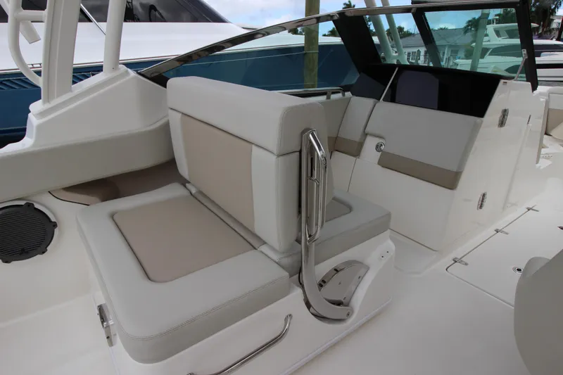 Slide: The Image of 2023 Boston Whaler 240 Vantage helm with navigation display and steering wheel. - 32