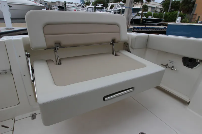 Slide: The Image of 2023 Boston Whaler 240 Vantage boat interior with helm, seating, and navigation system. - 35