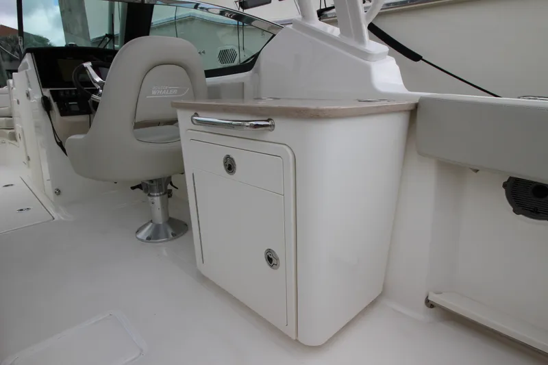 Slide: The Image of 2023 Boston Whaler 240 Vantage boat interior with cushioned seating and sleek design. - 36