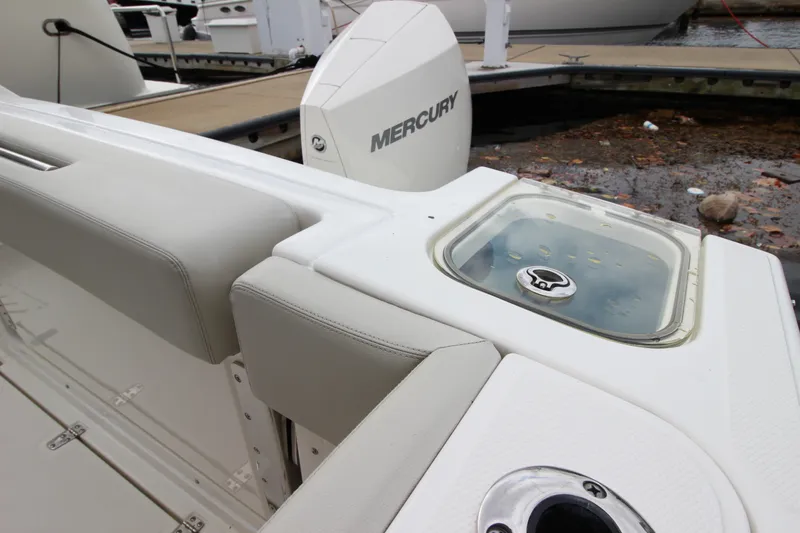 Slide: The Image of 2023 Boston Whaler 240 Vantage boat seat, showcasing foldable design and beige upholstery. - 41