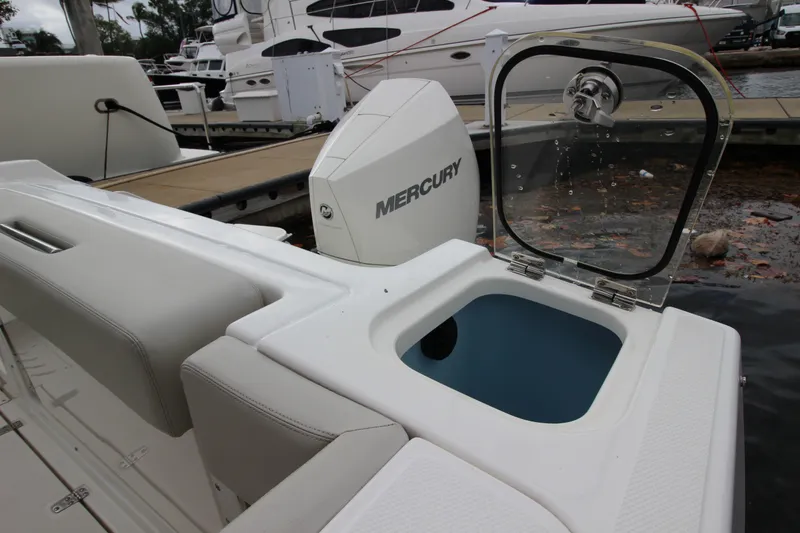Slide: The Image of 2023 Boston Whaler 240 Vantage interior with helm seat and storage cabinet. - 42
