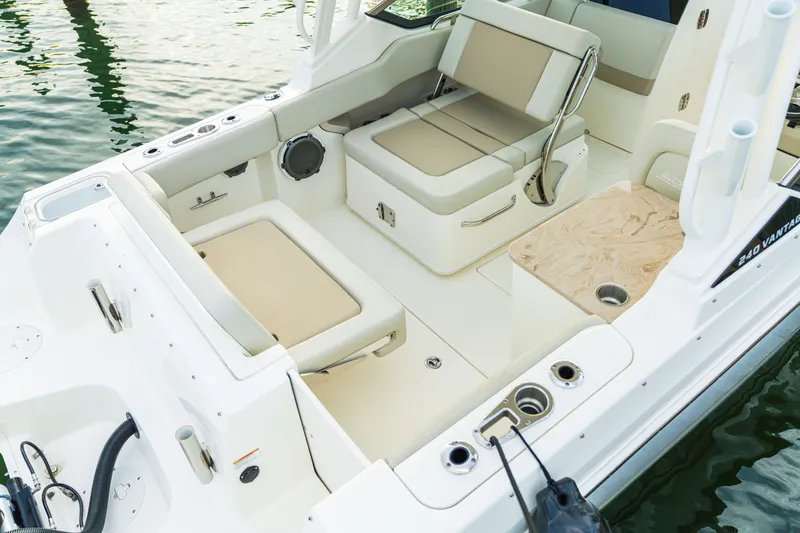 Slide: The Image of 2023 Boston Whaler 240 Vantage boat interior with beige seating and cup holders. - 5
