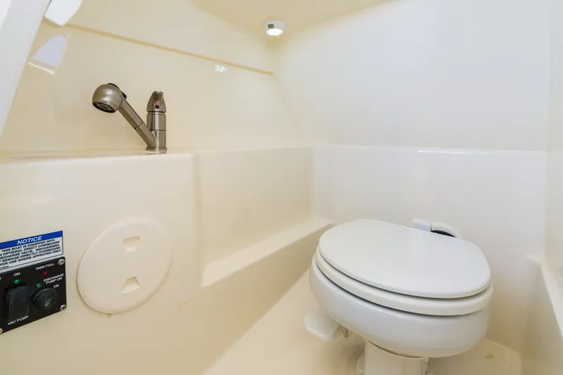 Slide: The Image of 2023 Boston Whaler 240 Vantage boat interior with toilet and faucet. - 7