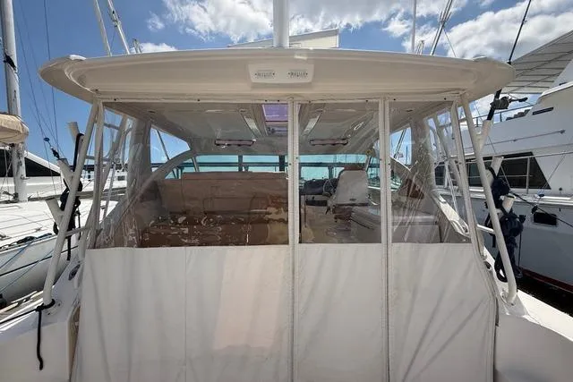 Slide: The Image of 2010 Tiara Yachts 3900 Open with covered cockpit, docked under a clear blue sky. - 10