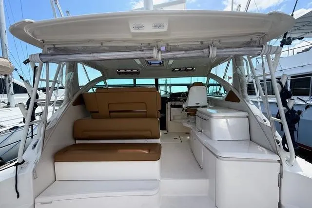 Slide: The Image of 2010 Tiara Yachts 3900 Open with spacious seating and sleek design in marina setting. - 11