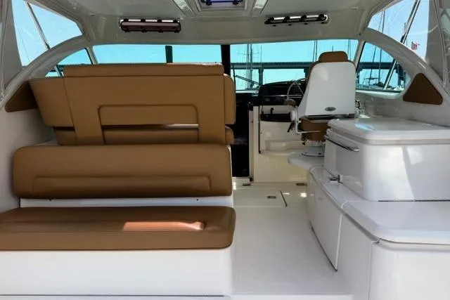 Slide: The Image of Interior of 2010 Tiara Yachts 3900 Open with tan seating and modern helm. - 12