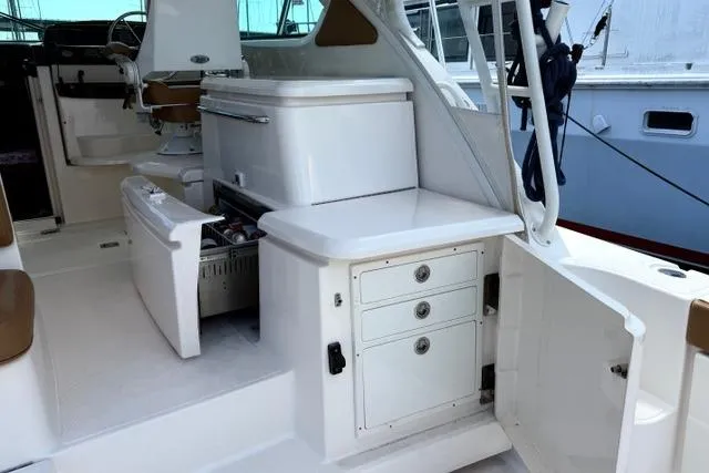 Slide: The Image of 2010 Tiara Yachts 3900 Open interior with storage and seating area. - 13