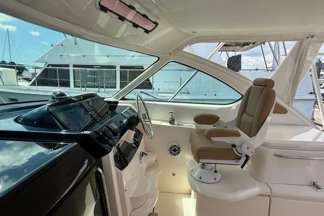 Slide: The Image of Interior view of 2010 Tiara Yachts 3900 Open helm with modern controls and seating. - 14