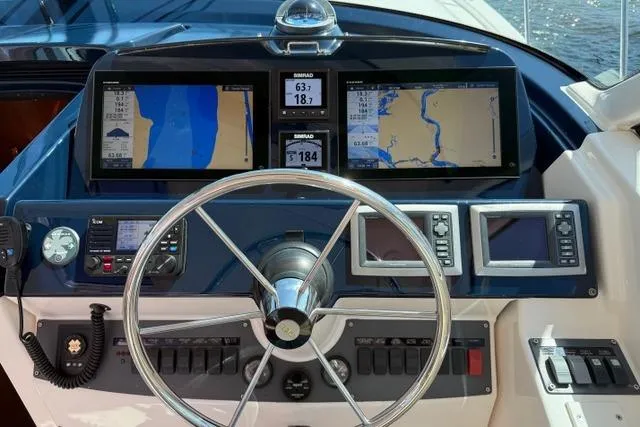 Slide: The Image of Helm of 2010 Tiara Yachts 3900 Open with navigation displays and controls. - 15