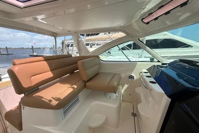 Slide: The Image of Interior of 2010 Tiara Yachts 3900 Open with tan seating and waterfront view. - 16