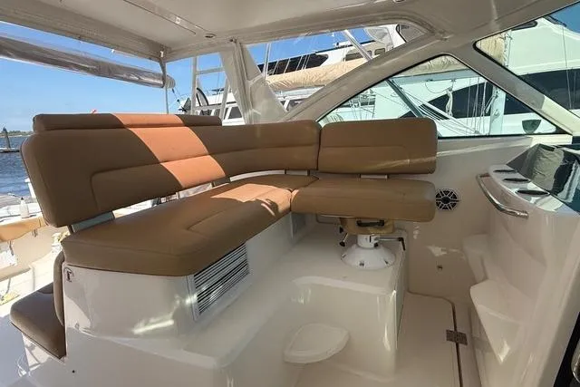 Slide: The Image of Interior seating of 2010 Tiara Yachts 3900 Open, featuring tan cushions and sleek design. - 17