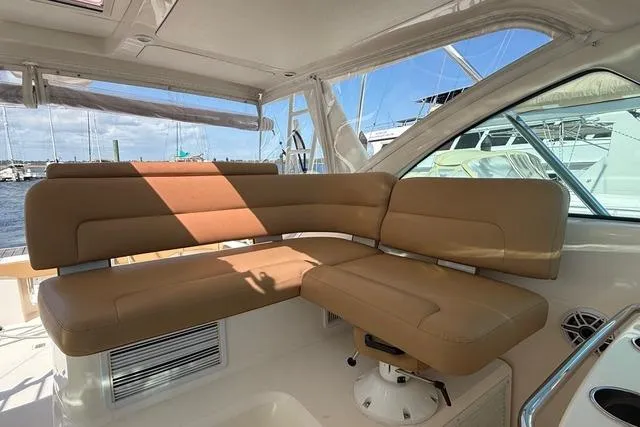 Slide: The Image of Luxurious seating area on a 2010 Tiara Yachts 3900 Open, with tan upholstery. - 18
