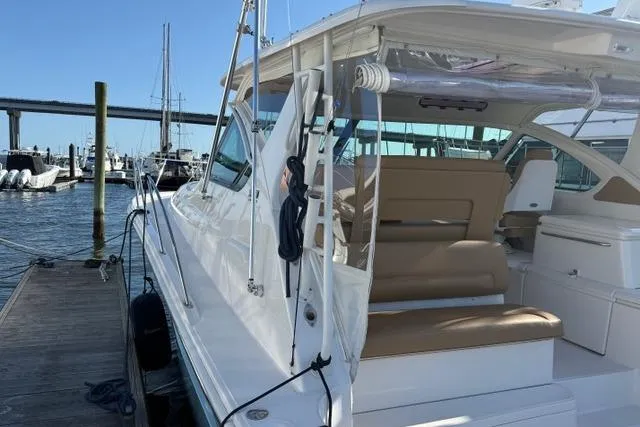 Slide: The Image of 2010 Tiara Yachts 3900 Open docked, showcasing sleek design and spacious seating. - 2