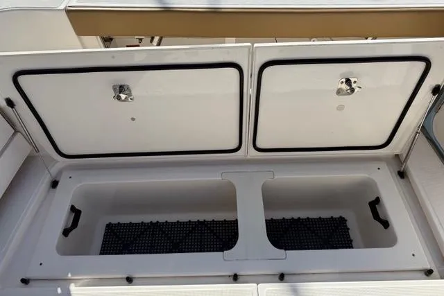 Slide: The Image of Storage compartment on a 2010 Tiara Yachts 3900 Open boat, featuring dual access doors. - 22