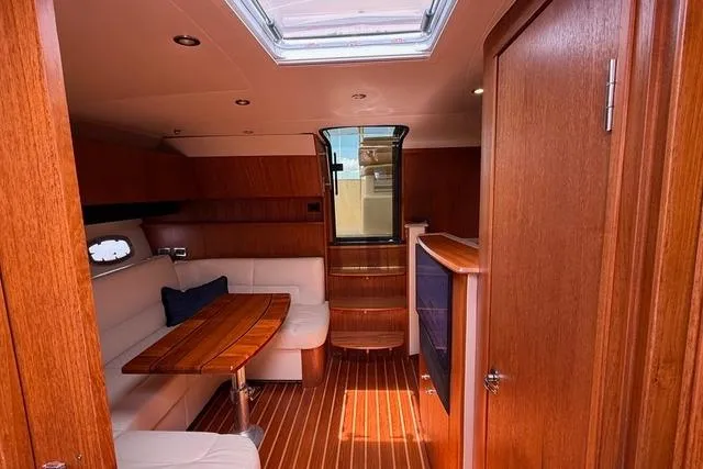 Slide: The Image of Interior of 2010 Tiara Yachts 3900 Open with wood finish and seating area. - 25