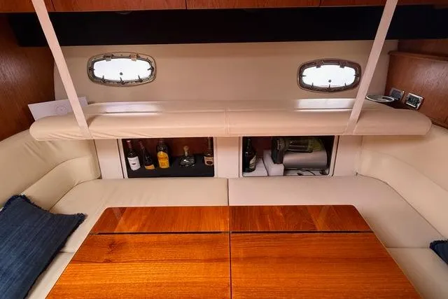 Slide: The Image of Interior of 2010 Tiara Yachts 3900 Open with elegant seating and wooden table. - 27