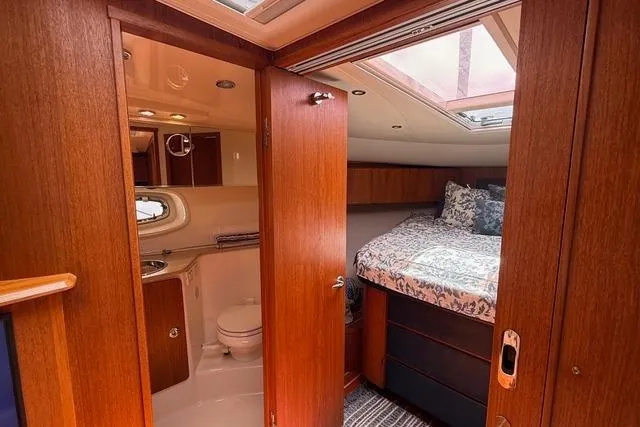 Slide: The Image of Interior of 2010 Tiara Yachts 3900 Open, featuring a cozy bedroom and bathroom. - 32