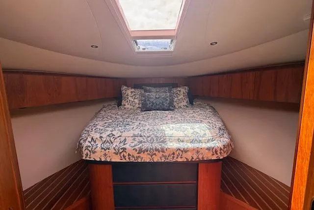 Slide: The Image of Luxurious cabin interior of 2010 Tiara Yachts 3900 Open with elegant bedding and wood finish. - 33