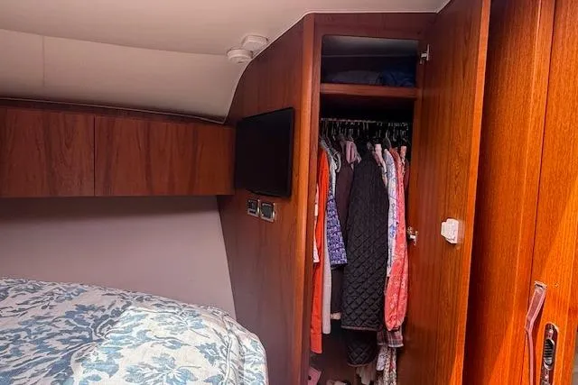 Slide: The Image of Interior cabin of 2010 Tiara Yachts 3900 Open with wooden closet and bed. - 34
