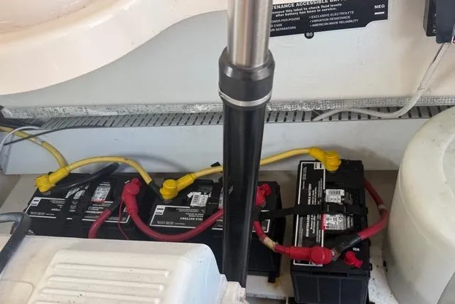Slide: The Image of Battery compartment of a 2010 Tiara Yachts 3900 Open, showing connected marine batteries. - 39