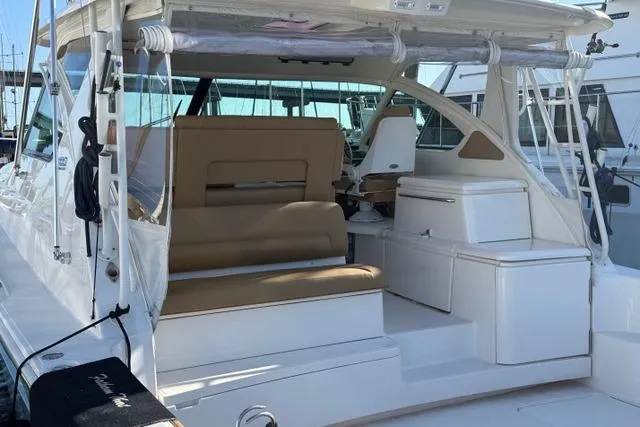 Slide: The Image of 2010 Tiara Yachts 3900 Open with beige seating, docked at a marina. - 4